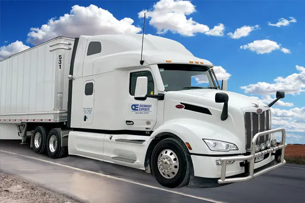 Truck on the road with clouds above